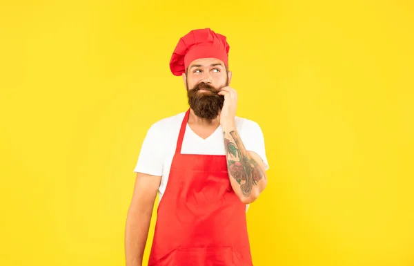 Hesitant Man Red Toque Apron Stroking Chin Yellow Background Chef — Photo