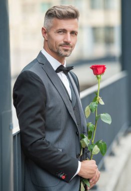 engagement date. smiling man celebrates engagement. man with rose gift for engagement.