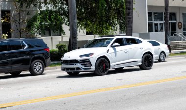 Miami Beach, Florida USA - April 15, 2021: 2019 white Giallo Auge Lamborghini Urus, corner view.