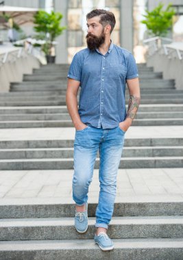 bearded guy walk downstairs. full length of guy with beard. caucasian guy outdoor.