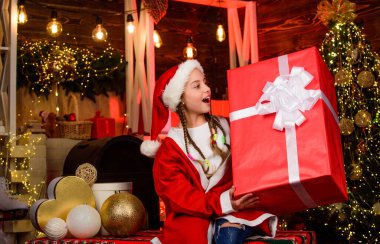 Child having fun christmas eve. Happiness and joy. Girl Santa claus received gift. Best gift for her. Shop purchase. Happy new year. Big surprise. Winter gift. Generous holiday. Rewarding concept.