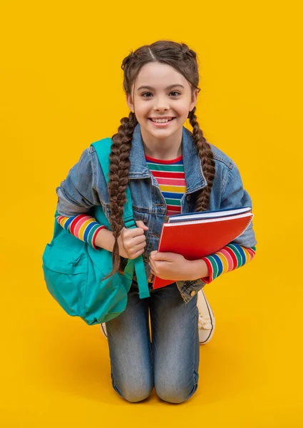 Happy Teenage Girl Kneeling Yellow Background School Education School Back — Stockfoto