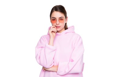Serious young woman in casual pink hoodie and glasses isolated on white, girl.