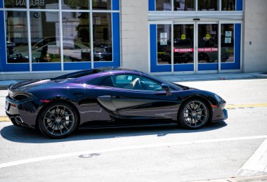 Miami Beach, Florida USA - April 15, 2021: mclaren exclusive 570GT MSO Black, side view.