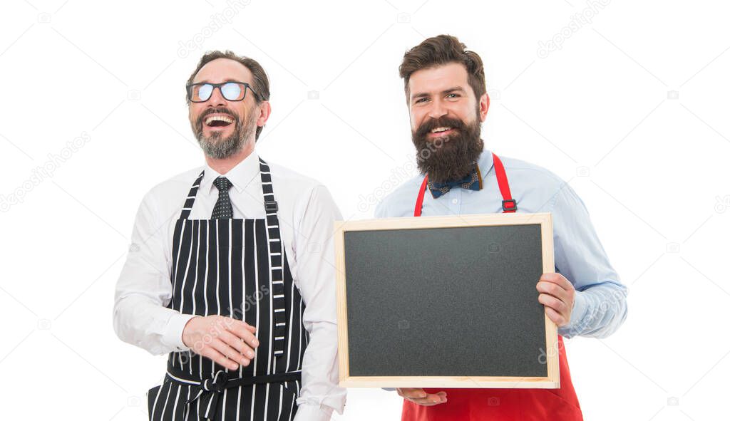 Everything is on schedule. cafe and restaurant opening. bearded men with blackboard, copy space. partners celebrate start up. menu planning. chef team in apron. catering business. welcome on board.