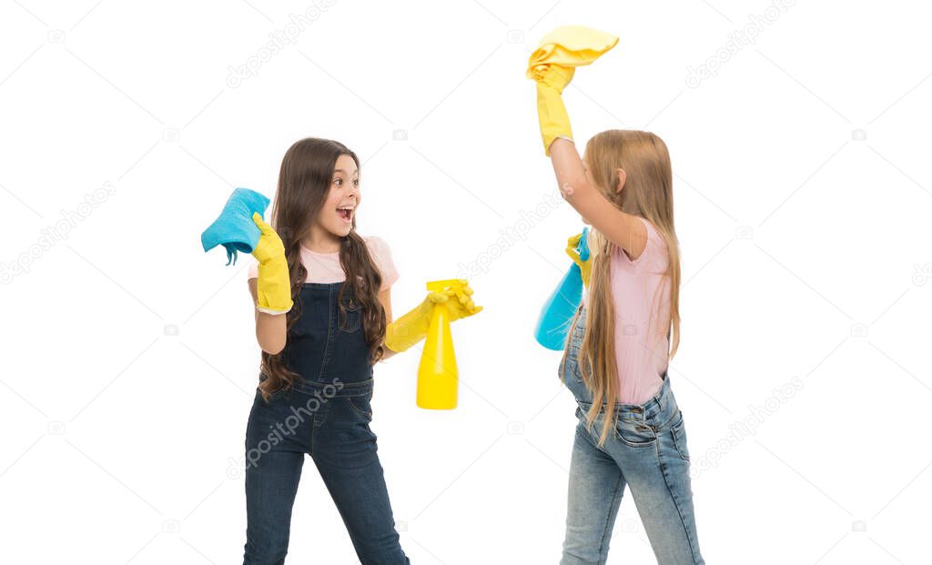 Cleaning their home naturally. Little cleaning ladies. Adorable children providing domestic cleaning with sprayers and wipers. Happy small girls wearing yellow rubber gloves for cleaning home.