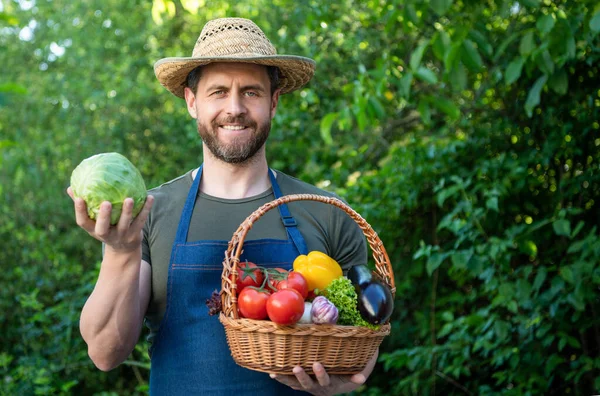 man in straw hat hold basket full of vegetables. copy space.