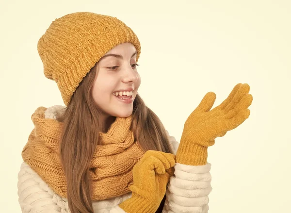In her own style. warm clothes. happy teen girl in winter clothes. childhood happiness. small kid wear knitwear isolated on white. child in hat gloves and sweater. autumn fashion style.