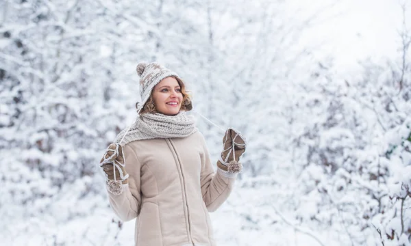 funny and happy woman. best holiday ever. girl warm clothing. Enjoying nature wintertime. Portrait of excited woman in winter wood. white snow tree. Girl in mittens and knitted hat.