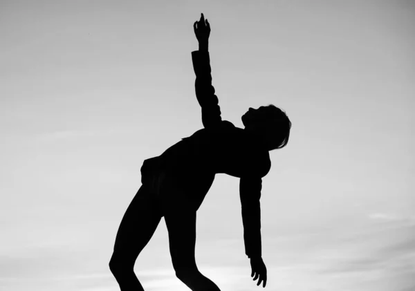being flexible. female silhouette on sunset. woman dance in dark. dark figure shape. girl dancing in dusk. shade and shadow. sensual woman silhouette on sky background. sensuality.