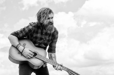 Sıradan bir adam performans sırasında insani duygularını ifade eder. Uzun saçlı hippi ve bıyıklı gitarist. Müzik aleti olan erkek gitarist. Country müzik konsepti. Sakallı adam akustik gitar çalar..