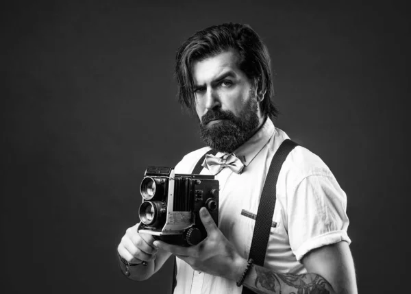 brutal bearded male with stylish look use vintage photo camera, journalist.