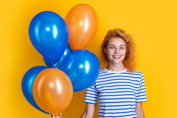 happy woman hold party balloons in studio. woman with balloon for party isolated on yellow background. party woman with balloon.