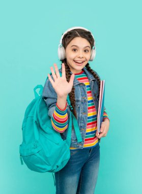 Hello school. Happy teen girl waving hand blue background, school. Back to school. September 1. Knowledge day.