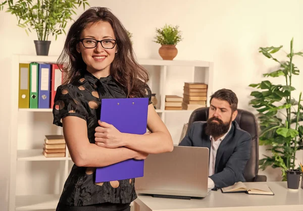 Happy professional woman employee in formalwear stand in front of manager working in office, work.