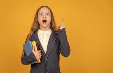 inspired with idea girl do homework with copybook. study with workbook. copy space. child holding book. back to school. childhood education. knowledge day. kid hold notebook. student in high school.