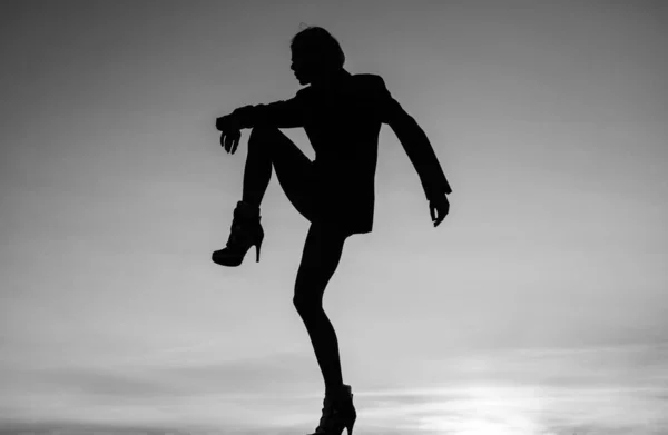 Feel the body. Dancing silhouette. Woman silhouette on evening sky. Dance girl. Mysterious performer. Shadow figure in dusk.