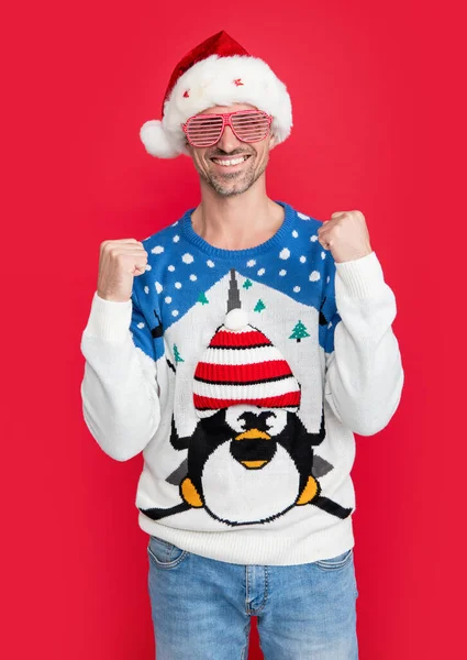 party on xmas holiday. man in party glasses on xmas holiday. full of happiness. man celebrate xmas holiday party isolated on red background.