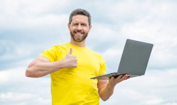 Mann Lächelt Online Arbeiten Auf Laptop Auf Himmel Hintergrund — Stockfoto