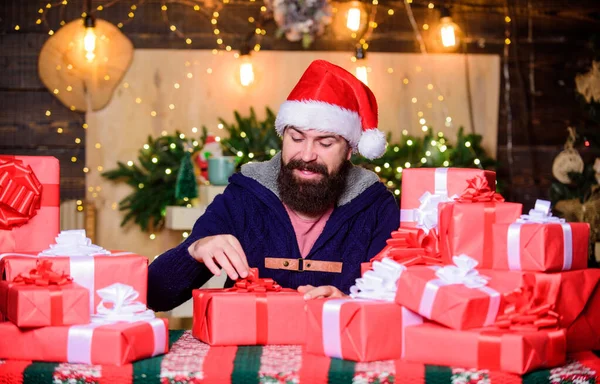 interesting what is inside. happy new year. Xmas present box. shopping sales. holiday celebration. hipster santa hat. Christmas shopping. christmas presents delivery. Boxing day. happy bearded man.