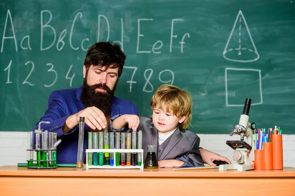 Genius kid. Joys and challenges raising gifted child. Teacher bearded scientist man child test tubes. Chemical experiment. Genius minds. Special and unique. Genius child private lesson. Knowledge day.
