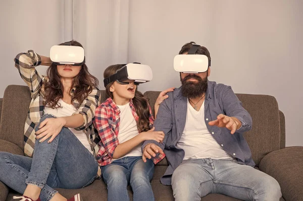 modern life. father mother and child VR glasses. virtual reality family. happy parents with kid girl use modern technology. mom dad and daughter. digital future and innovation.