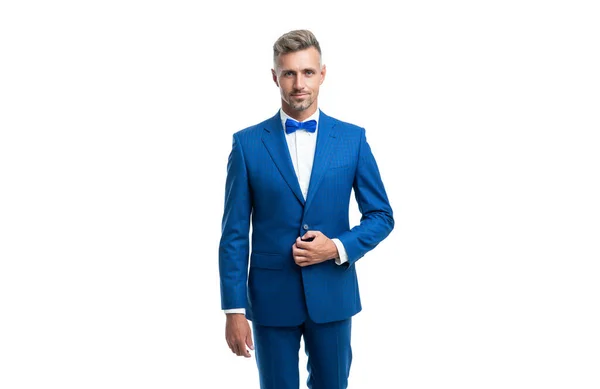 stock image confident formal man in blue tuxedo bowtie isolated on white background.