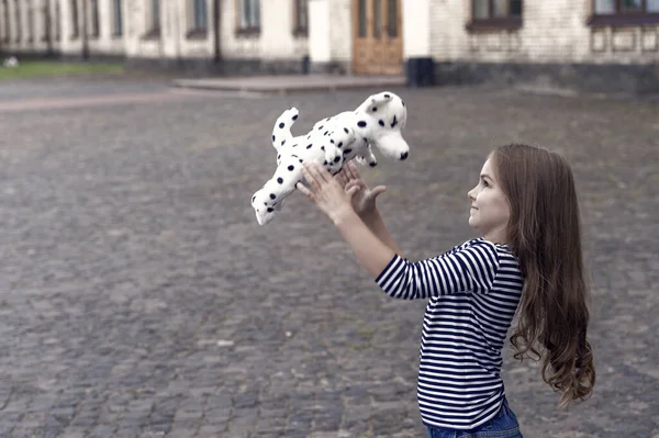 Life full of fun. Happy kid play with toy dog outdoors. Enjoying playtime. Play and fun. Childhood fun. Leisure and free time. Active games. Summer vacation. International childrens day, copy space.