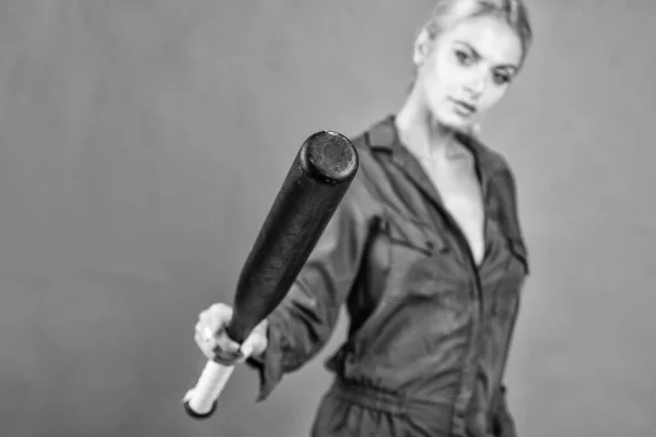 baseball bat in hand of woman. female baseball player. sports and games. cricket player on orange background. girl holding sport equipment or accessory. active wear. rounders game. selective focus.