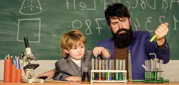 Genius minds. Special and unique. Genius child private lesson. Knowledge day. Genius kid. Joys and challenges raising gifted child. Teacher bearded scientist man child test tubes. Chemical experiment.