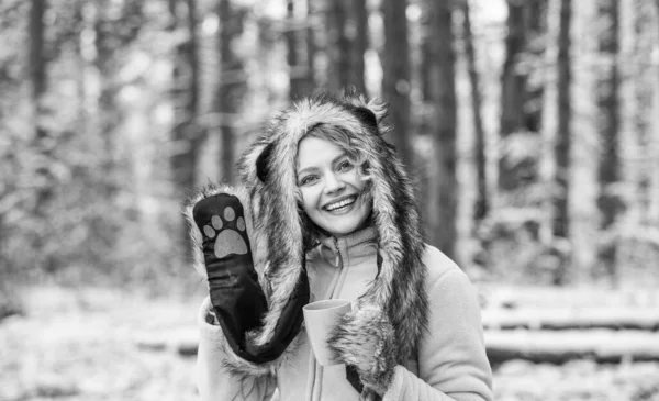 Faux fur animal hat perfect for fantasy theme. Heartwarming concept. Animal care. Winter themed portrait cosy outfit. Woman wear wolf hat. Animal rights. Wild life symbol. Girl in snowy forest.