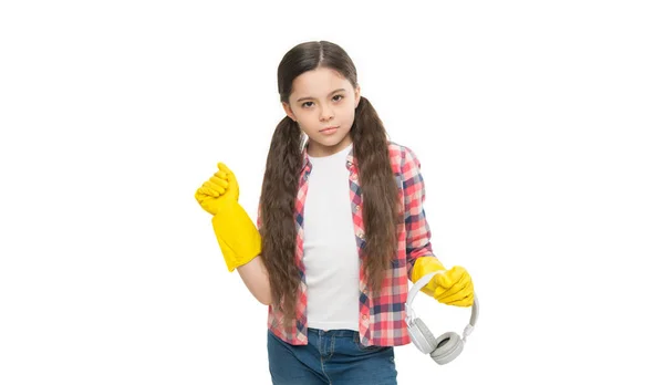 Cleaning routine. Girl wear headphones and gloves for cleaning. Instead of procrastinating try make cleaning little bit easier with fun. Make household more joyful. Listening music and cleaning house.