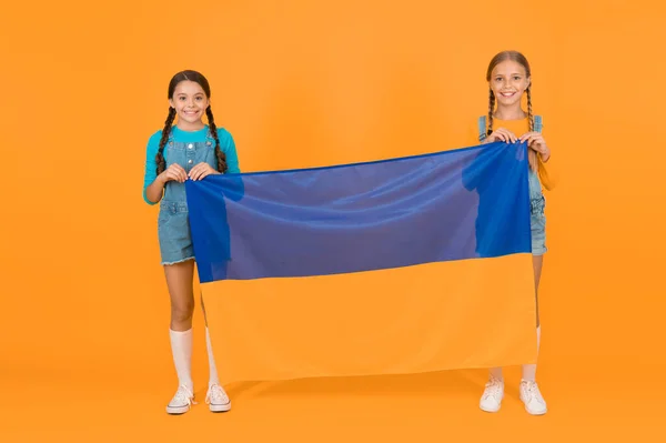 Ukrainian kids. Girls with blue and yellow flag. Patriotic education. Happy independence day. Children hold ukrainian flag. Patriotism respect and love to motherland. National identity concept.