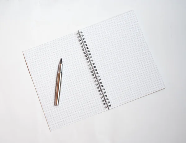 Pen on white notebook — Stock Photo, Image