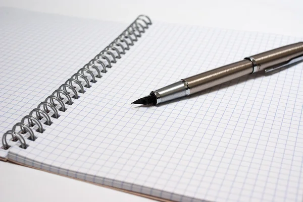 Pen on white notebook — Stock Photo, Image