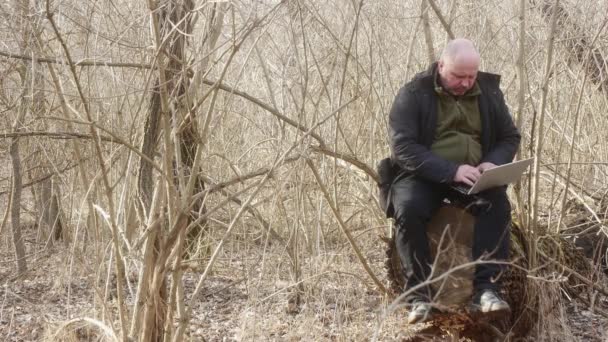 Ein Mann Einem Dichten Wald Sitzt Auf Einem Großen Baumstumpf — Stockvideo