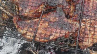 chicken meat with burnt crust, grilled, close-up, over the ash pit.