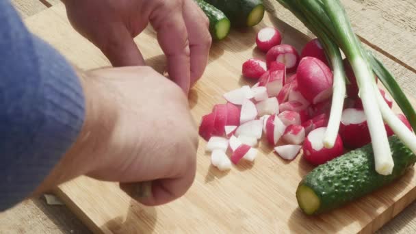 Man Hand Cuts Red Radish Knife Next Leek Cucumbers — Stock Video