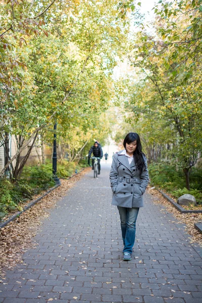 Woman walking down a road — Stock Photo, Image