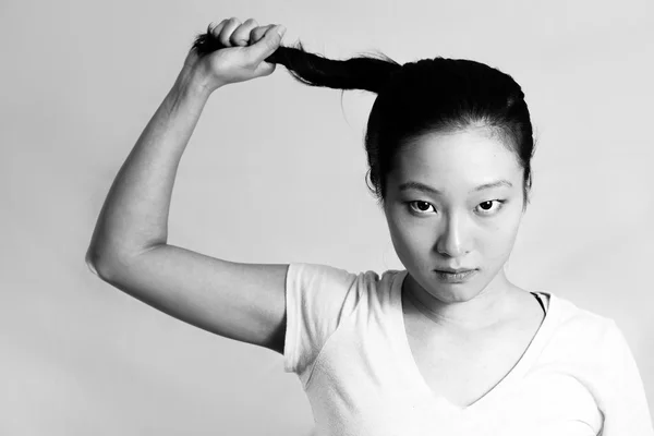 Young girl pulling her hair — Stock Photo, Image