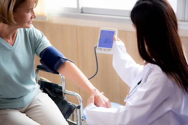 Medico Donna Uniforme Misurazione Della Pressione Sanguigna Con Pazienti Anziani — Foto Stock