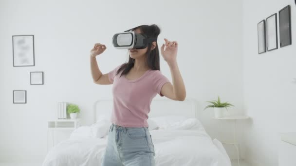 Young Asian Woman Wearing Headset Playing Game Excited Bed Bedroom — Stock Video