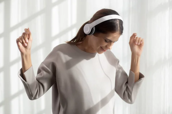Happy Young Asian Woman Wearing Headphones Listening Music While Dancing — Stok fotoğraf