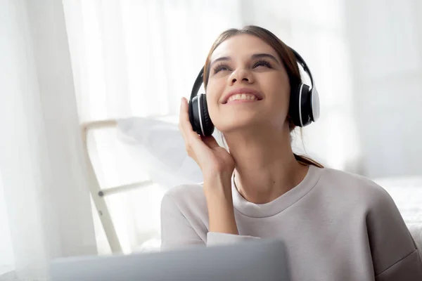 Happy Young Woman Wearing Headphones Listening Music While Using Laptop — Photo