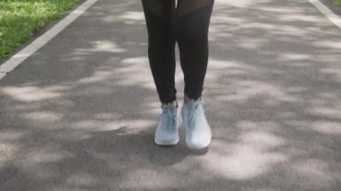 Closeup leg and foot of woman workout with jogging or running on summer in the park, girl exercise for relax with sport on tropical in the garden, one person, health care and sportive concept.