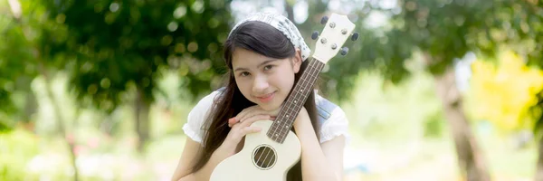 Happiness Young Asian Woman Sitting Playing Ukulele While Relaxation Entertainment — Stok fotoğraf