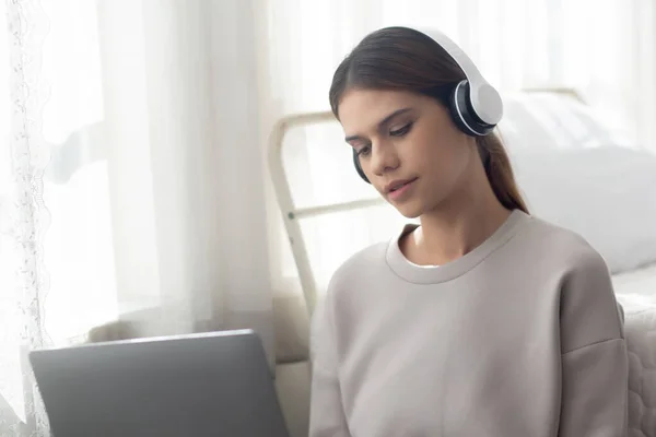 Happy Young Woman Wearing Headphones Listening Music While Using Laptop — Φωτογραφία Αρχείου