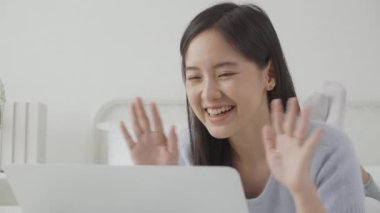 Young asian woman using laptop computer for video conference online with friends, businesswoman working with video call for meeting with social network, business and communication concept.