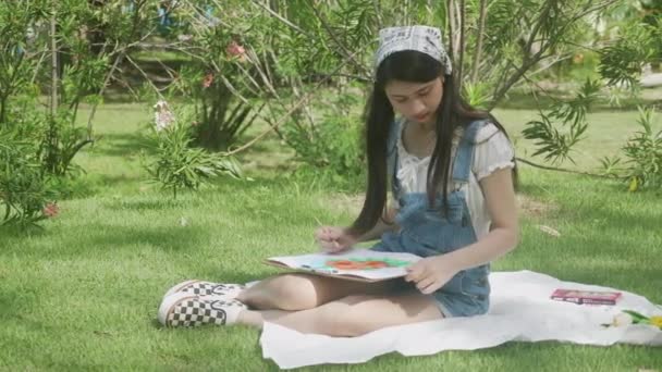 Young Asian Woman Sitting Drawing Picture Colorful Paint Brush While — Stock Video