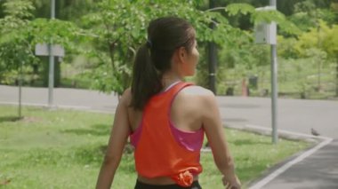 Beautiful young asian woman workout with jogging or walking on summer in the park, girl exercise for relax with sport on tropical in the garden, one person, health care and sportive concept.
